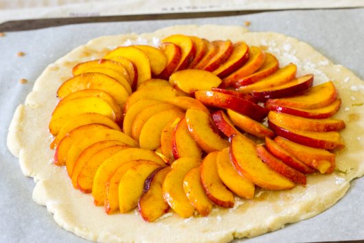 arranging the fruit for Rustic Peach Galette