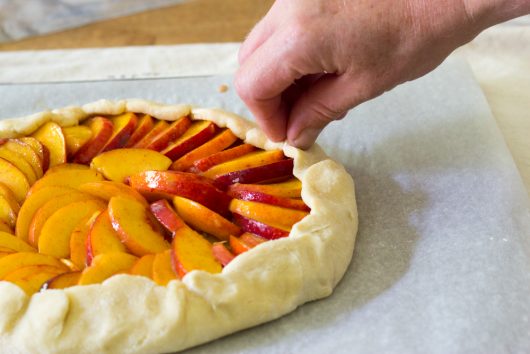 folding and pleating the dough for Rustic Peach Galette