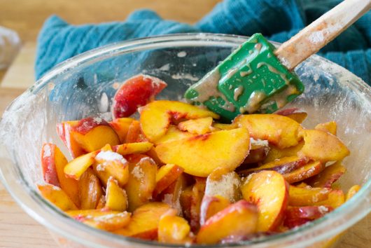 tossing the fruit for Rustic Peach Galette