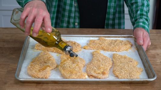 drizzle cutlets with olive oil for Crispy Baked Chicken Parmesan