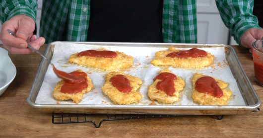 spoon cutlets with tomato sauce for Crispy Baked Chicken Parmesan
